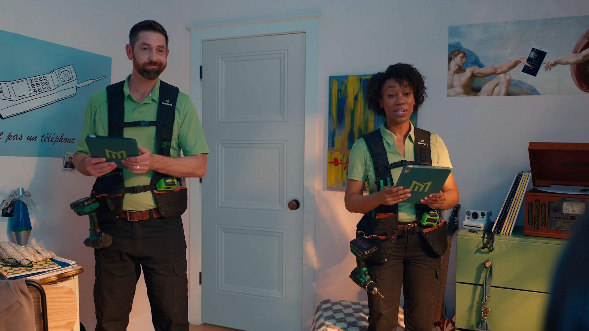 two people standing in front of a bedroom door